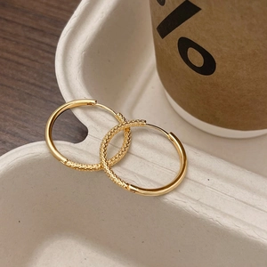 French vintage gold hoop earrings featuring unique irregular and textured surfaces