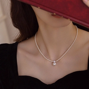 Elegant pearl necklace with large pendant and zircon accents on a single strand chain