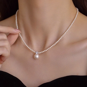 Elegant pearl and zircon pendant necklace with handcrafted gold-plated beads on a model