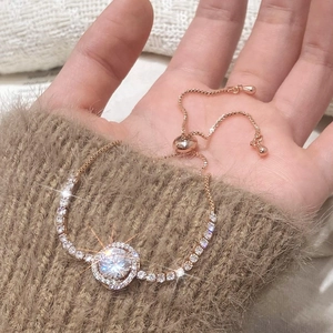 Rose gold slider bracelet with sparkling round main stone and tennis chain accents
