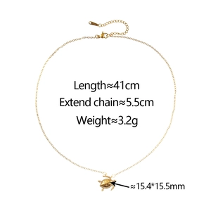 Detail of gold sea turtle pendant with zircon inlay and adjustable stainless steel chain