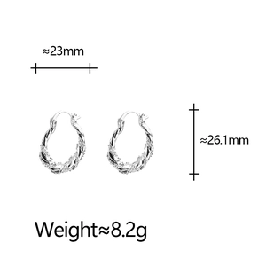 Detailed view of silver twist earrings with zircon pavé setting and size measurements