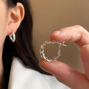 Minimalist silver braided twist hoop earrings for women with elegant metallic texture