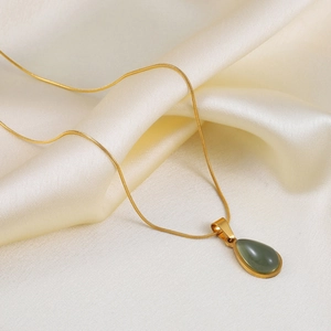 Gold snake chain necklace featuring a teardrop-shaped olive green stone pendant