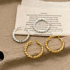 Chic twisted metal hoop earrings in gold and silver finish with retro textured design