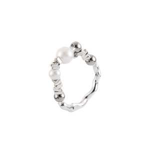 Detail of handcrafted wavy silver ring featuring pearls and irregular metallic beads