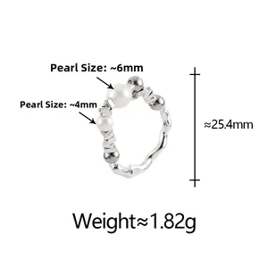 Detail of silver textured ring with 6mm and 4mm white pearls and molten metal finish