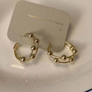 Double-layered golden bead hoop earrings with a minimalist vintage luxury design for women