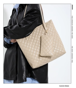 Detail of beige quilted tote bag featuring a matching small pouch and soft PU texture
