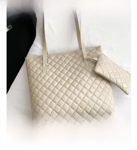 Detail view of the quilted tote bag with matching pouch and slim shoulder straps