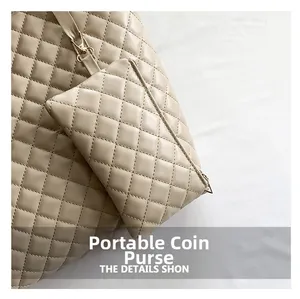 Detail of beige quilted tote bag featuring a detachable small matching coin purse