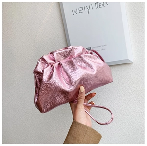 Close-up of pink metallic ruched cloud bag with textured synthetic leather finish