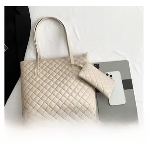Detailed comparison of the beige quilted tote bag size with a tablet and phone