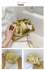 Detailed view of gold drawstring bucket bag with pleated texture and metallic finish