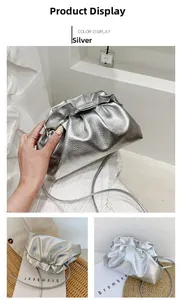 Detailed close-up of metallic silver pleated cloud bag with thin strap and soft faux leather texture