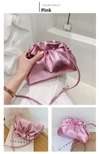 Detailed view of the metallic pink ruched bucket bag with fine lychee leather texture