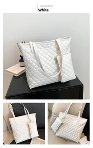 Close-up of white quilted tote bag and matching pouch showing菱格 texture and stitching