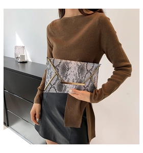 Fashionable envelope clutch bag with snake print texture and gold metal bar detail