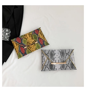 Detail of snake skin print envelope clutch bags with gold metal bar magnetic closure