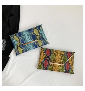 Detail of snakeskin envelope clutch bags with gold metal trim in vibrant mixed colors