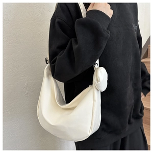 Detail of white crescent crossbody bag set with adjustable strap and coin purse