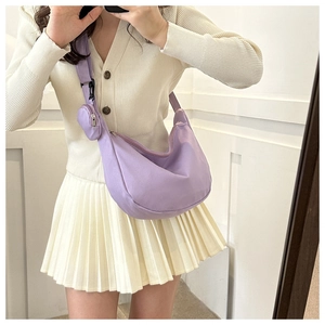 Detail of purple crescent shoulder bag with detachable mini pouch and nylon texture