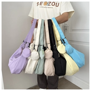 Minimalist nylon dumpling crossbody bags in multiple colors with wide adjustable straps