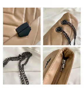 Detailed views of V-quilted beige shoulder bag with dark grey metal chain and zipper details