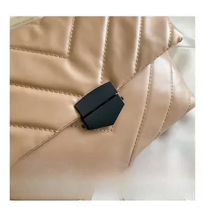 Close-up of khaki quilted leather bag with black matte geometric metal buckle detail