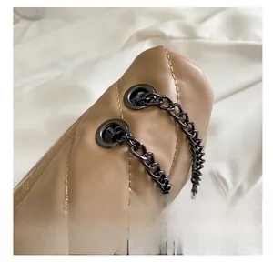 Detail of khaki quilted leather bag with gunmetal chain and fine stitching texture