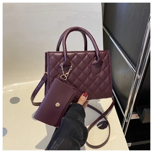 Détail du sac à main rouge vin matelassé avec petit porte-monnaie assorti et chaîne dorée