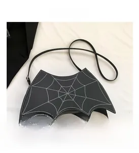 Detail view of gothic bat-shaped crossbody bag with white spider web stitching