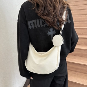Minimalist beige crescent crossbody bag with mini pouch and adjustable wide strap
