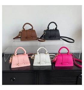 Trapezoid mini handbags in five colors on acrylic stands featuring pebble leather texture