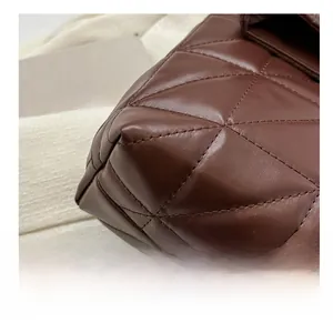 Macro shot of brown quilted leather bag corner showing high-quality stitching detail