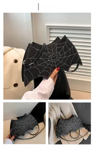Detail of bat-wing shaped handbag with white spiderweb stitching and heart detail