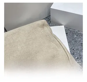 Close-up of beige high-density knit cotton fabric with natural rolled edge details