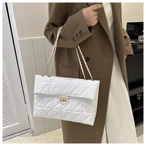 Detail of white quilted leather shoulder bag with gold chain strap and turn-lock closure