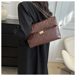 Detailed view of dark brown quilted PU leather shoulder bag with gold twist lock and chain