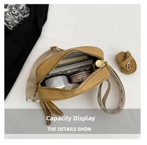 Top view of khaki leather crossbody bag showing large interior capacity with essentials