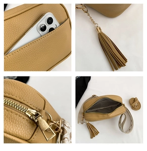 Detail view of khaki camera bag with wide jacquard strap and gold zipper closure