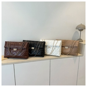 Detailed row of quilted crossbody bags in burgundy, black, white, and caramel brown