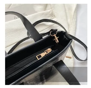 Detail of the smooth golden zipper closure and metal D-ring on black wool bucket bag