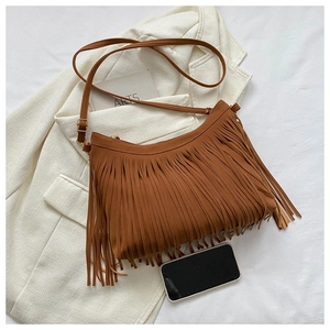 Detailed view of caramel suede tote bag with long fringes and matte finish texture