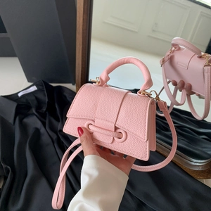 Pink lychee texture mini crossbody bag with top handle and elegant flip-top closure