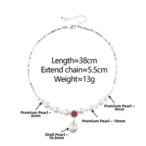 Detailed view of pearl necklace with 18.8mm teardrop shell pendant and red gemstone