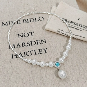 Vintage pearl necklace featuring faceted silver beads and a large teardrop pearl pendant