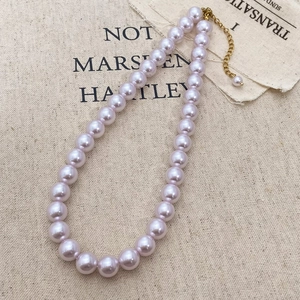 Detail of lavender pearl necklace with gold clasp and adjustable extension chain