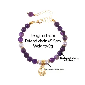 Detailed shot of amethyst and pearl beaded necklace with a golden Fu pendant charm