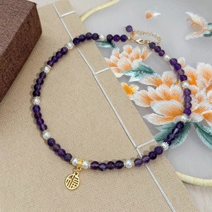Handmade necklace with purple amethyst, white pearls and gold Fu character pendant